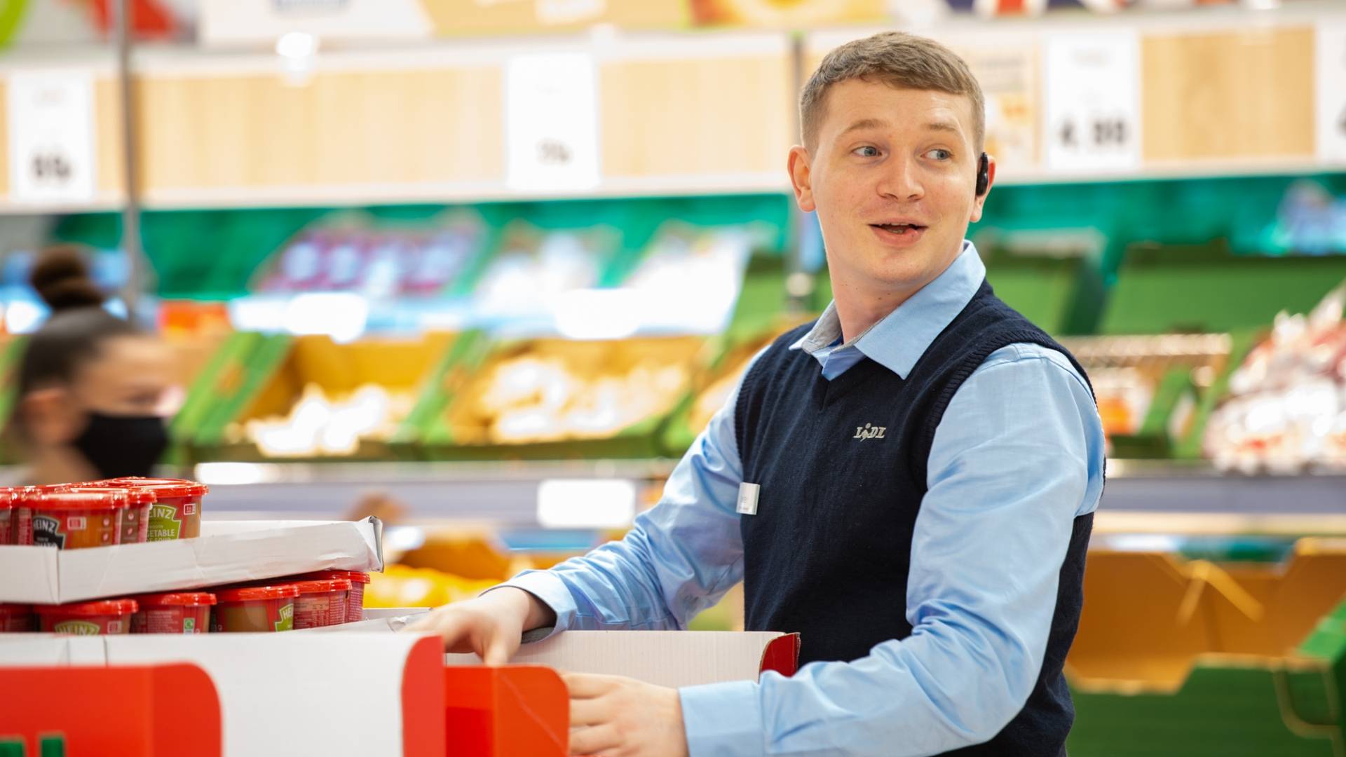 Customer Assistant tidying up Heinz soup selection