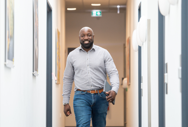 RO smiling in the hallway